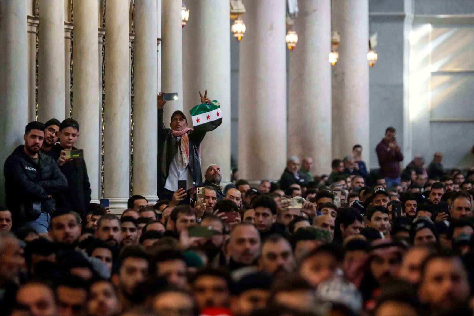 Syrians attend Friday prayers inside the 7th century Umayyad Mosque in Damascus, Syria, Friday, Dec. 13, 2024. (AP Photo/Omar Sanadiki)