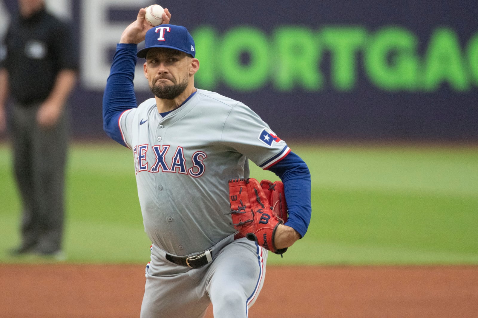 FILE - Texas Rangers starting pitcher Nathan Eovaldi delivers against the Cleveland Guardians during the first inning of a baseball game in Cleveland, Friday, Aug. 23, 2024. (AP Photo/Phil Long, File)