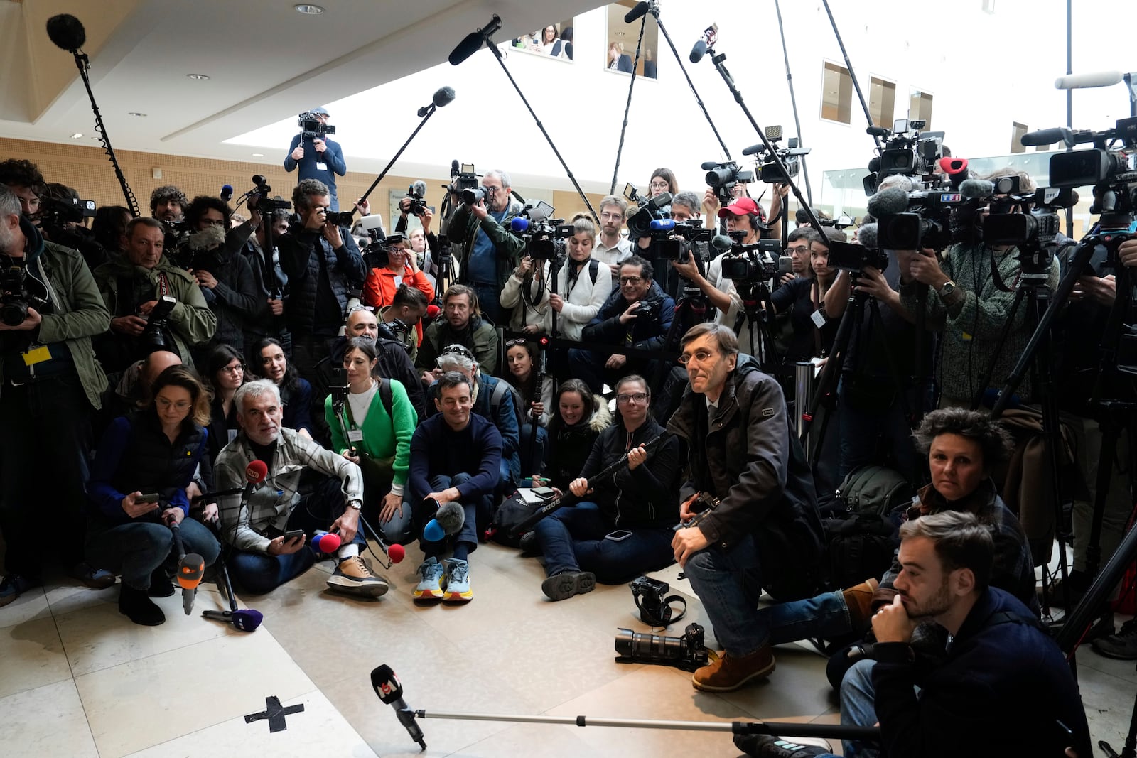 Members of the media wait inside the Avignon courthouse, southern France, Thursday, Dec. 19, 2024. (AP Photo/Lewis Joly)