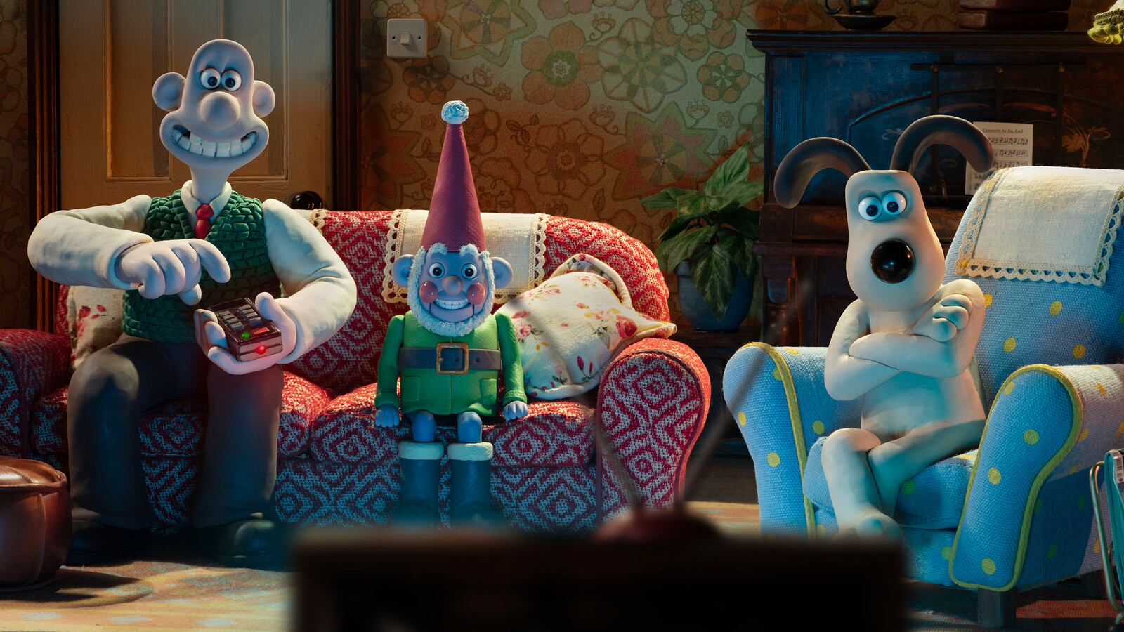 This image released by Netflix shows the characters Wallace, voiced by Ben Whitehead, left, Norbot, voiced by Reece Shearsmith, center, and Gromit in a scene from the film "Wallace & Gromit: Vengeance Most Fowl." (Netflix via AP)