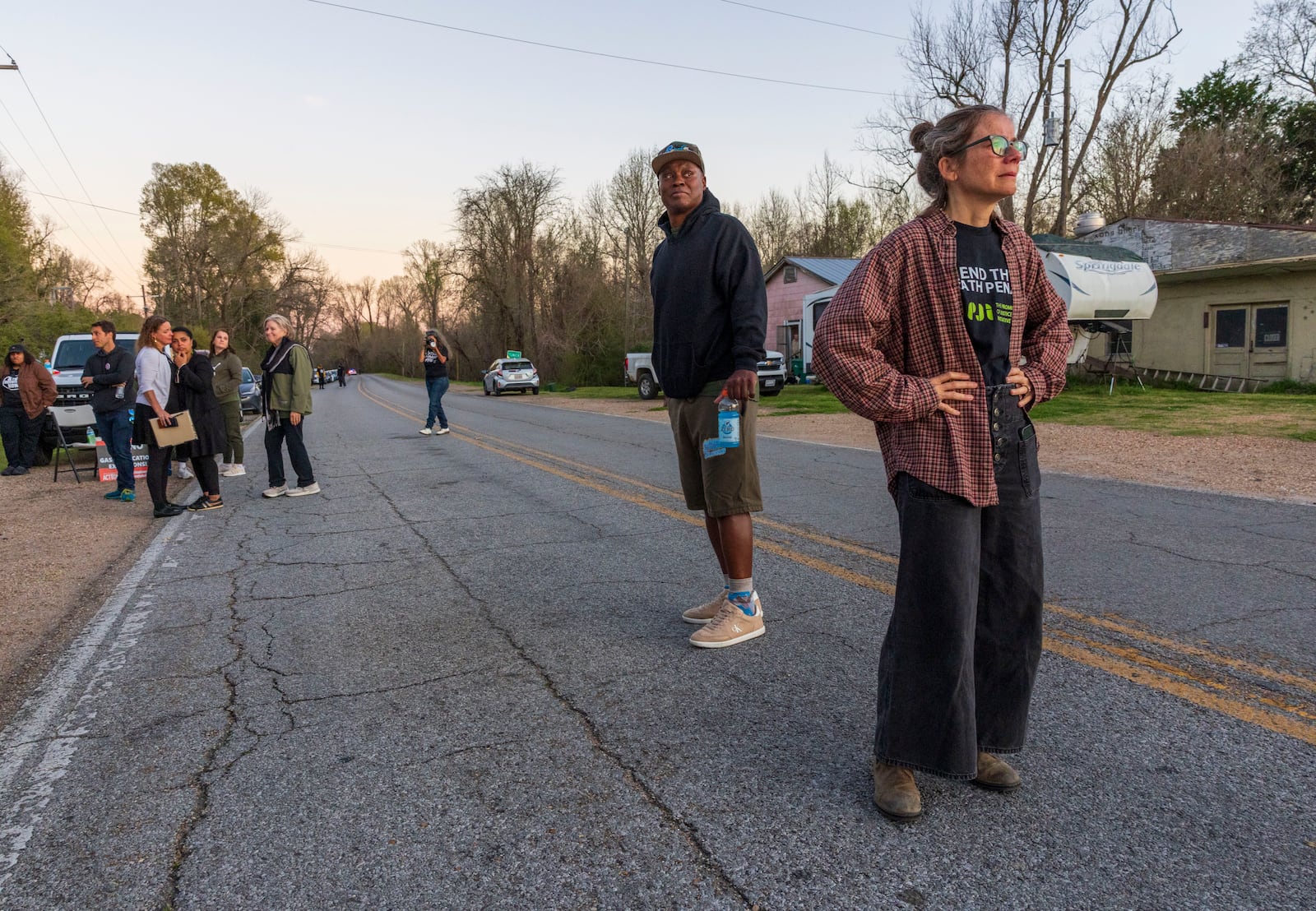 Faith leaders, activists, and supporters of Jessie Hoffman, Jr., stand in the street as they stare at the entrance to Louisiana State Penitentiary in Angola, La., moments after hearing that Hoffman was executed Tuesday, March 18, 2025. (Chris Granger/The Times-Picayune/The New Orleans Advocate via AP)