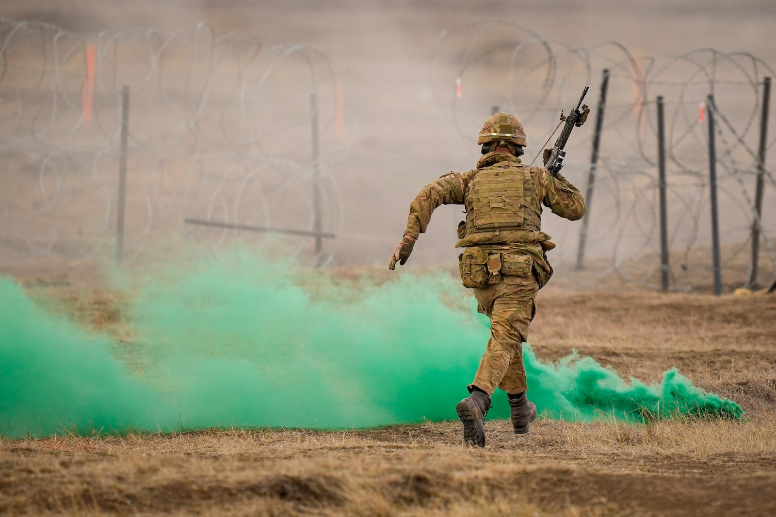 A serviceman runs during the Steadfast Dart 2025 exercise, involving some 10,000 troops in three different countries from nine nations and represent the largest NATO operation planned this year, at a training range in Smardan, eastern Romania, Wednesday, Feb. 19, 2025. (AP Photo/Vadim Ghirda)