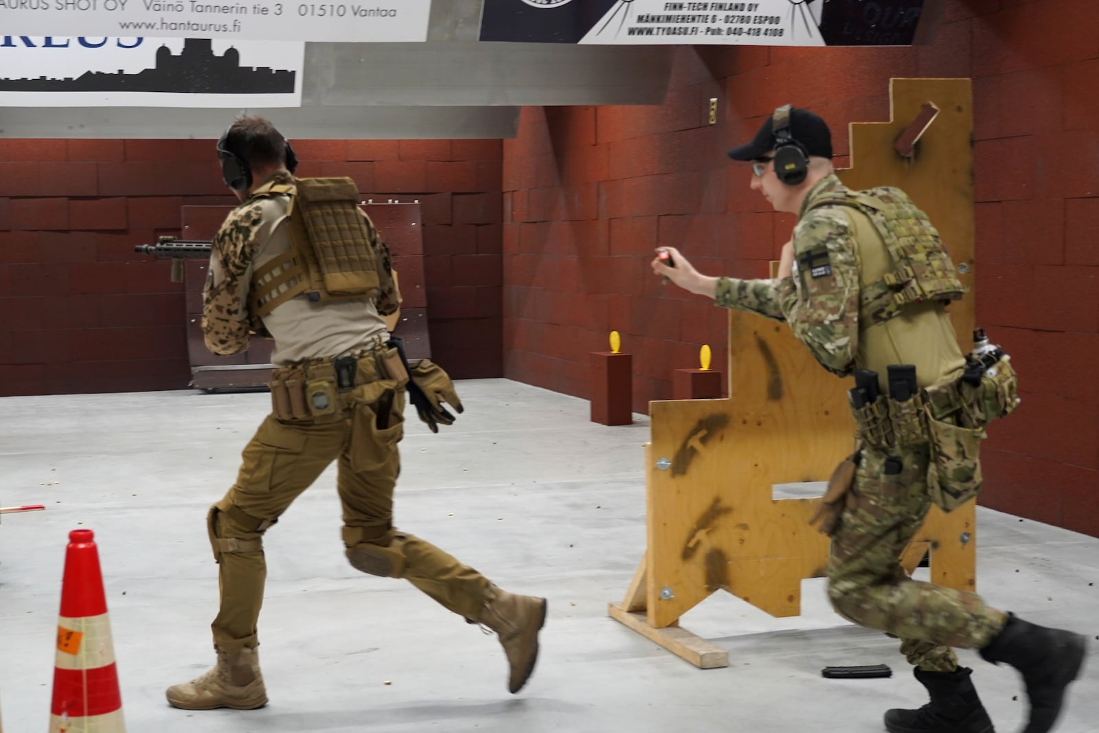 Members of the Vantaa Reservists Association practice at a shooting range in a warehouse in Kerava on the outskirts of Helsinki, Finland Monday, Dec. 2, 2024. (AP Photo/James Brooks)