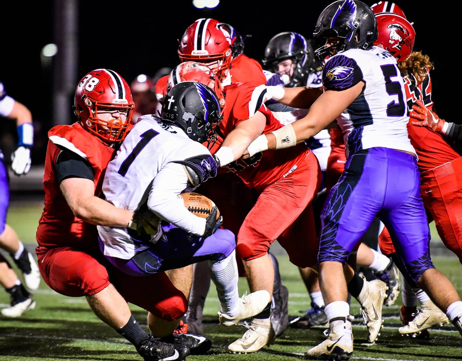 Madison’s Max Evans wraps up Cincinnati Hills Christian Academy’s D.J. Ames for a tackle during their 50-6 win over CHCA in a Division V, Region 20 semifinal Nov. 10 at Lakota East. NICK GRAHAM/STAFF