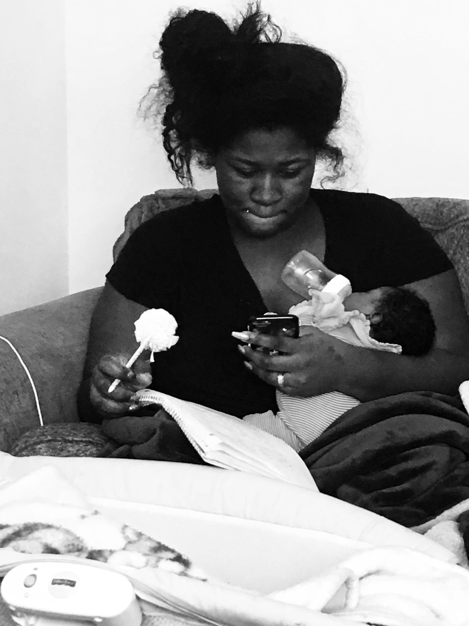 Dionna Walker multi-tasking feeding her newborn and working on her latest book, The Mommy Hustle