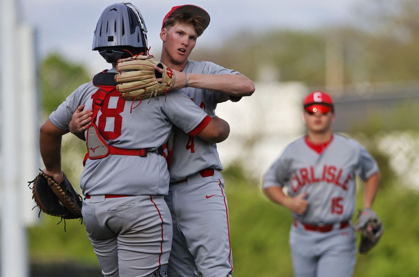 Carlisle catcher Isaiah Brady, left, celebrates with pitcher Brendon Rowe after their 7-1 win over Madison in their Reds Futures High School Showcase baseball game Monday, April 21, 2025 at the P&G MLB Cincinnati Reds Youth Academy. NICK GRAHAM/STAFF