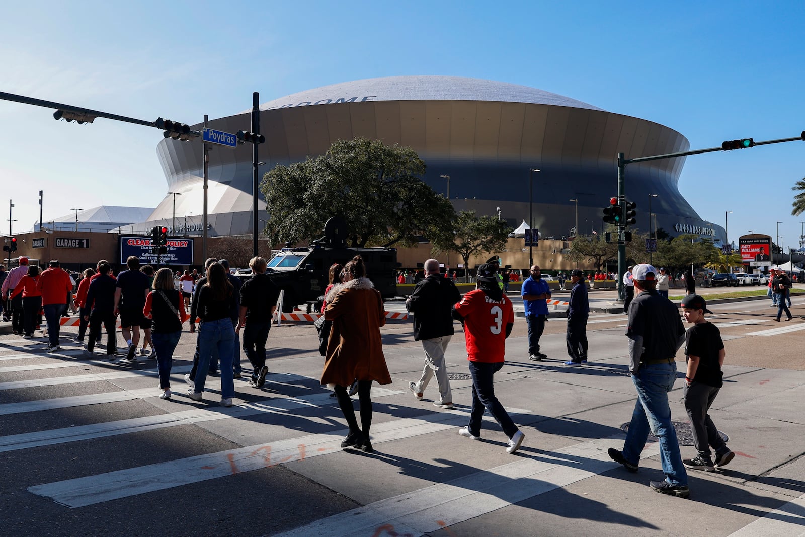 Fans walk towards the Caesars Superdome ahead of the Sugar Bowl NCAA College Football Playoff game, Thursday, Jan. 2, 2025, in New Orleans. (AP Photo/Butch Dill)