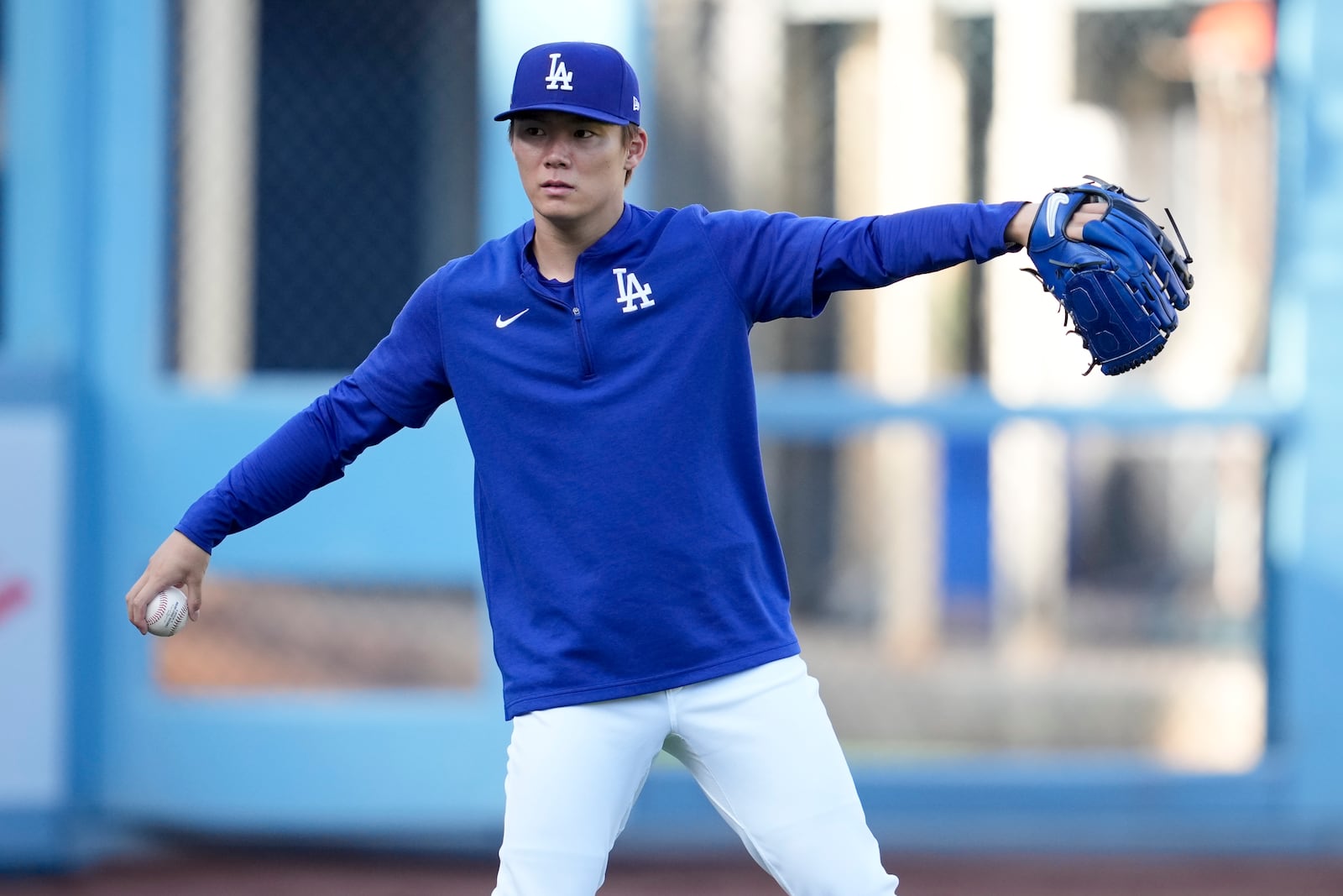 Los Angeles Dodgers pitcher Yoshinobu Yamamoto throws on the field ahead of Game 5 of a baseball National League Division Series against the San Diego Padres, Thursday, Oct. 10, 2024, in Los Angeles. (AP Photo/Ashley Landis)