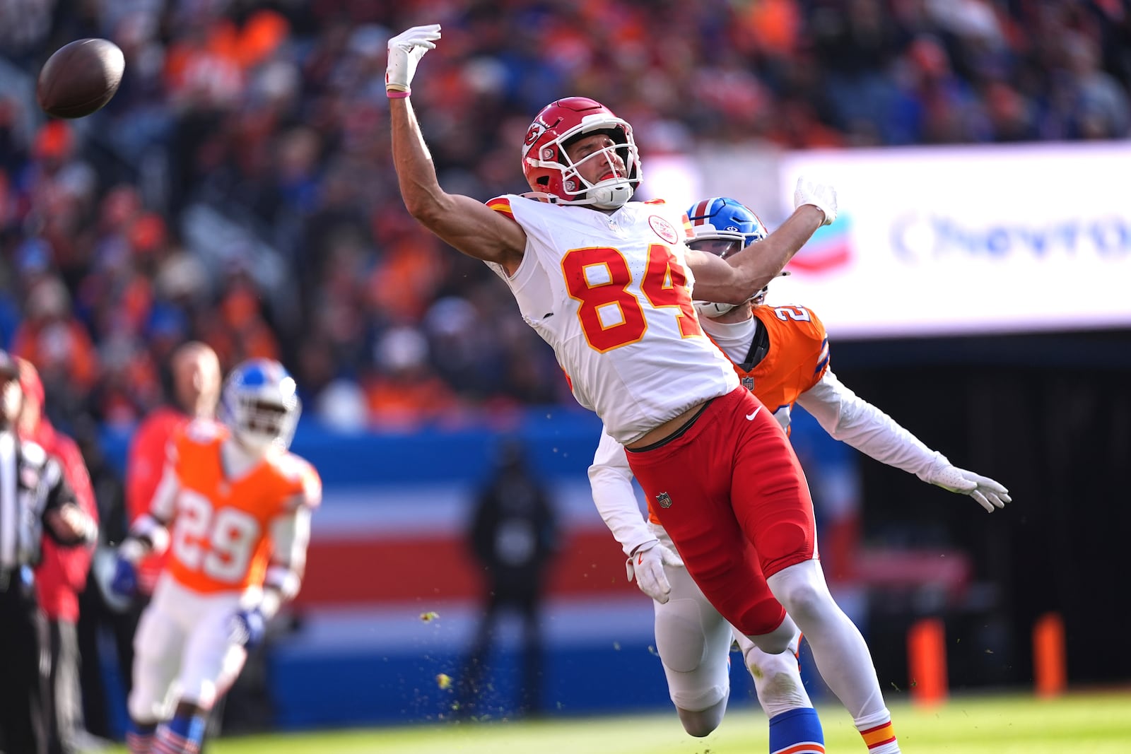 Kansas City Chiefs wide receiver Justin Watson (84) is unable to catch a pass as Denver Broncos cornerback Riley Moss (21) defends during the first half of an NFL football game Sunday, Jan. 5, 2025, in Denver. (AP Photo/David Zalubowski)