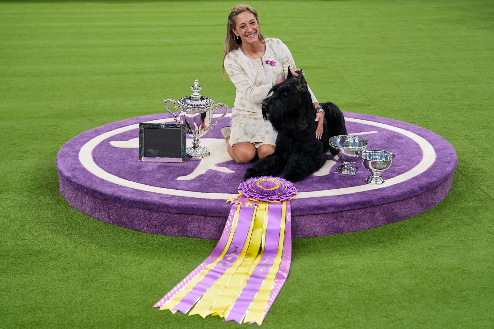 Katie Bernardin and Monty, a Giant Schnauzer, celebrate after winning best in show in the 149th Westminster Kennel Club Dog show, Tuesday, Feb. 11, 2025, in New York. (AP Photo/Julia Demaree Nikhinson)