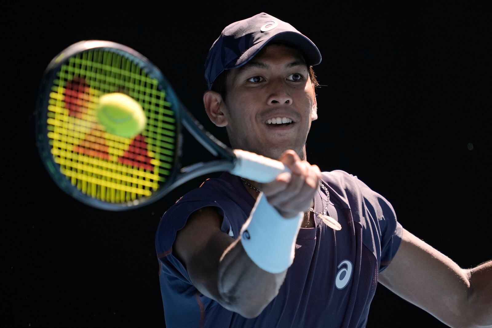 Kasidit Samrej of Thailand plays a forehand return to Daniil Medvedev of Russia during their first round match at the Australian Open tennis championship in Melbourne, Australia, Tuesday, Jan. 14, 2025. (AP Photo/Ng Han Guan)