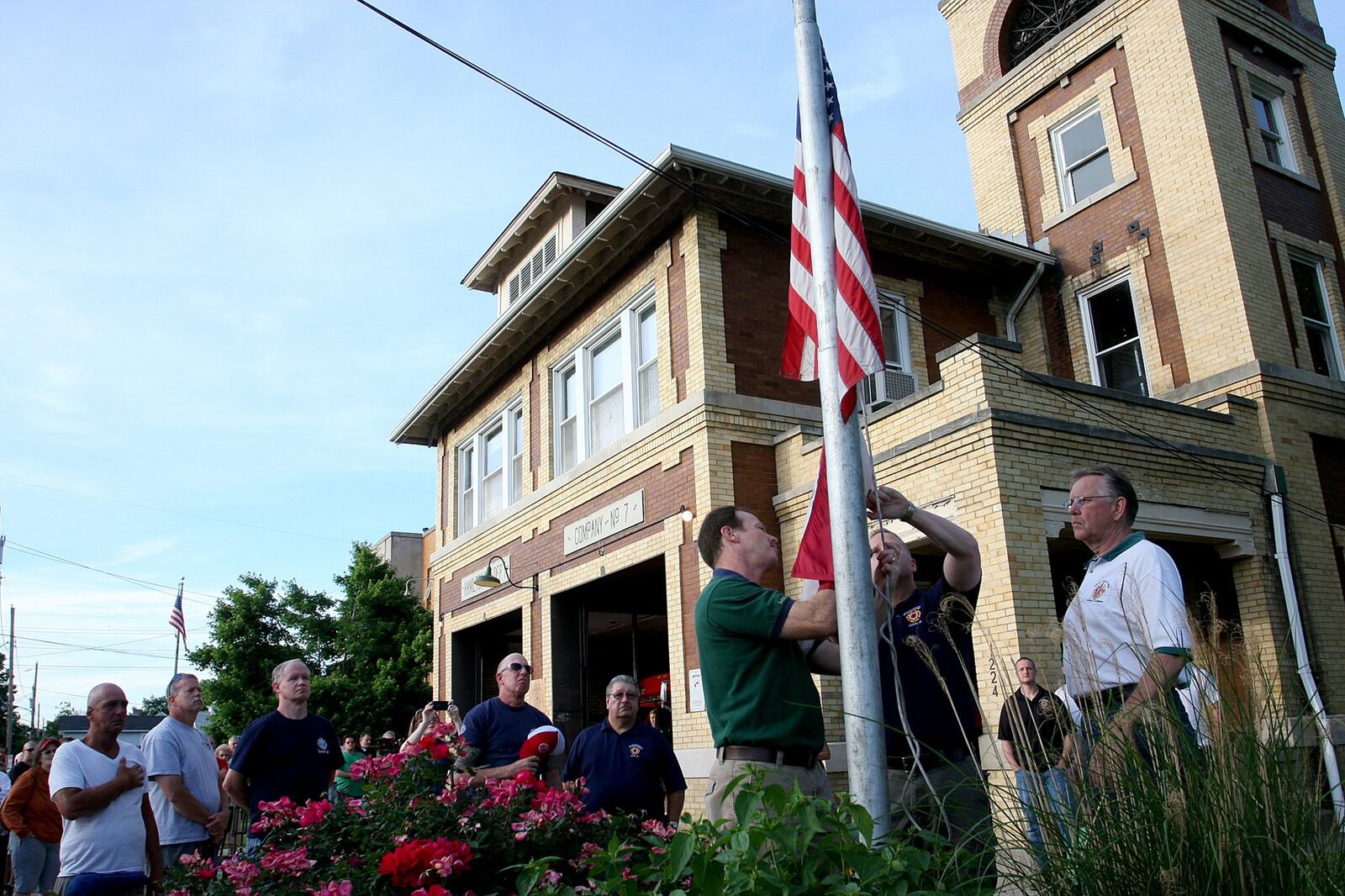 In 2013, Lt. Nathaniel Robertson and firefighter/paramedic David Oakley took down the American flag from Company 7 on Shuler Avenue. Community members gathered Tuesday evening at the firehouse for a ceremony closing the station in Hamilton.