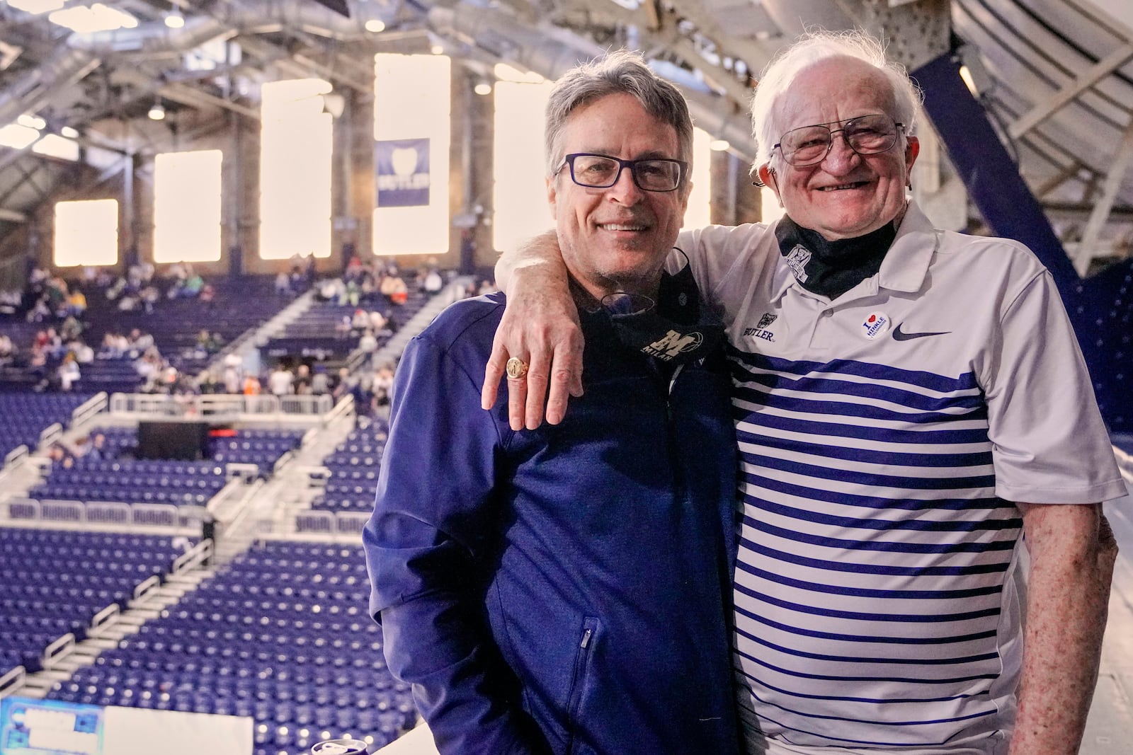 FILE - Bobby Plump, right, star of the 1954 Milan state championship basketball team that inspired the movie "Hoosiers," poses for a portrait with the movie's writer, Angelo Pizzo, March 27, 2021, during a Sweet 16 NCAA men's college basketball game at Hinkle Fieldhouse in Indianapolis. (AP Photo/AJ Mast, File)