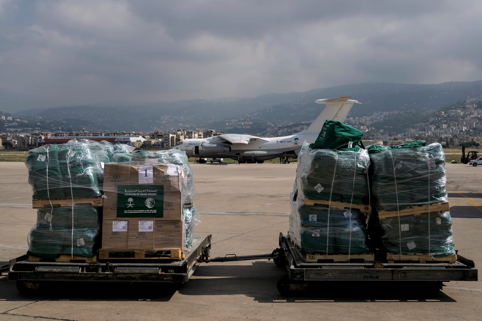 Workers unload Saudi medical aid boxes arriving at Beirut International airport, Lebanon, Sunday, Oct. 13, 2024. (AP Photo/Bilal Hussein)