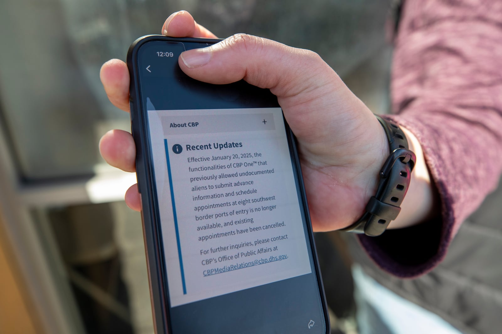 A volunteer with a pro-migrant organization shows the updated message of the CBP One app advising the cancellations of existing appointments for migrants that were scheduled to enter the United States on Monday, Jan. 20, 2025, in El Paso, Texas. (AP Photo/Andres Leighton)