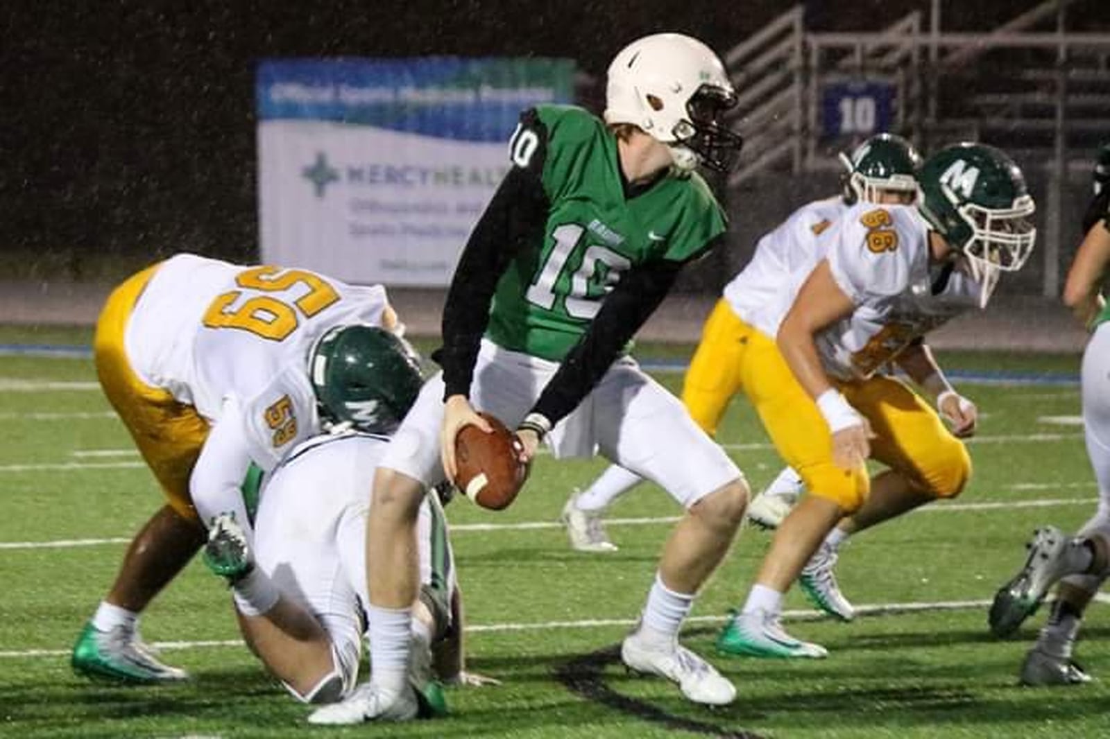 Badin quarterback Zach Switzer prepares to make a pitch Friday night during a game against McNicholas at Virgil Schwarm Stadium in Hamilton. CONTRIBUTED PHOTO BY TERRI ADAMS