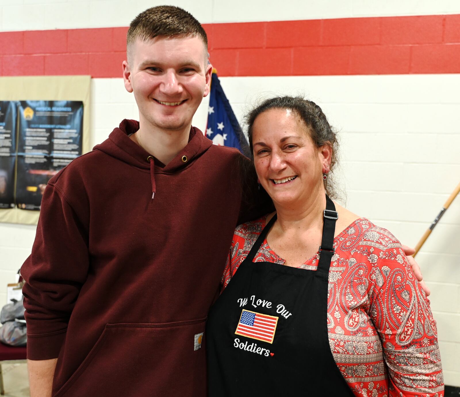 Spec. Ben Leonhardt, of Hamilton, poses with his mom, Angela Leonhardt, during the National Guard Armory Christmas party on Dec. 8, 2024. This was Ben Leonhardt's last drill weekend as he separates from the military as he focuses on his career as a nurse in civilian life. His mother led the organization of the Christmas party for 237th BSB Delta Company and HHT 2nd 107th Calvary Squadron soldiers and their families as Delta Company’s Soldier Family Readiness Group leader. MICHAEL D. PITMAN/STAFF