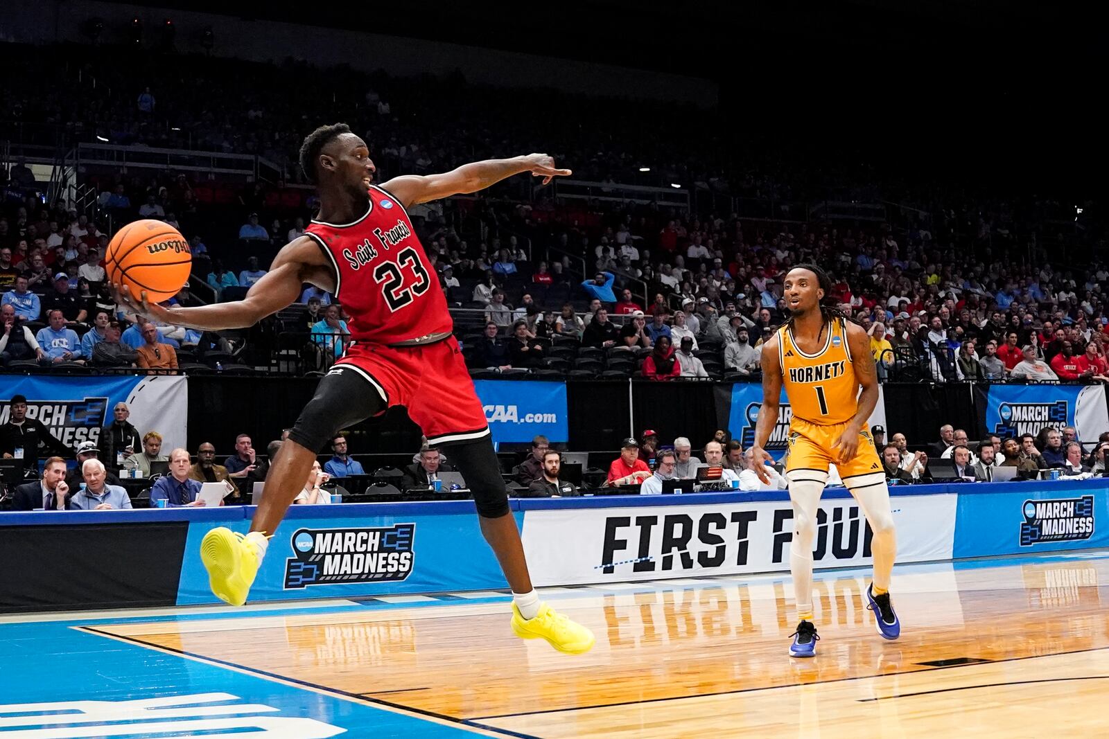 Saint Francis guard Wisler Sanon II (23) chases a loose ball during the first half of a First Four college basketball game against Alabama State in the NCAA Tournament, Tuesday, March 18, 2025, in Dayton, Ohio. (AP Photo/Jeff Dean)