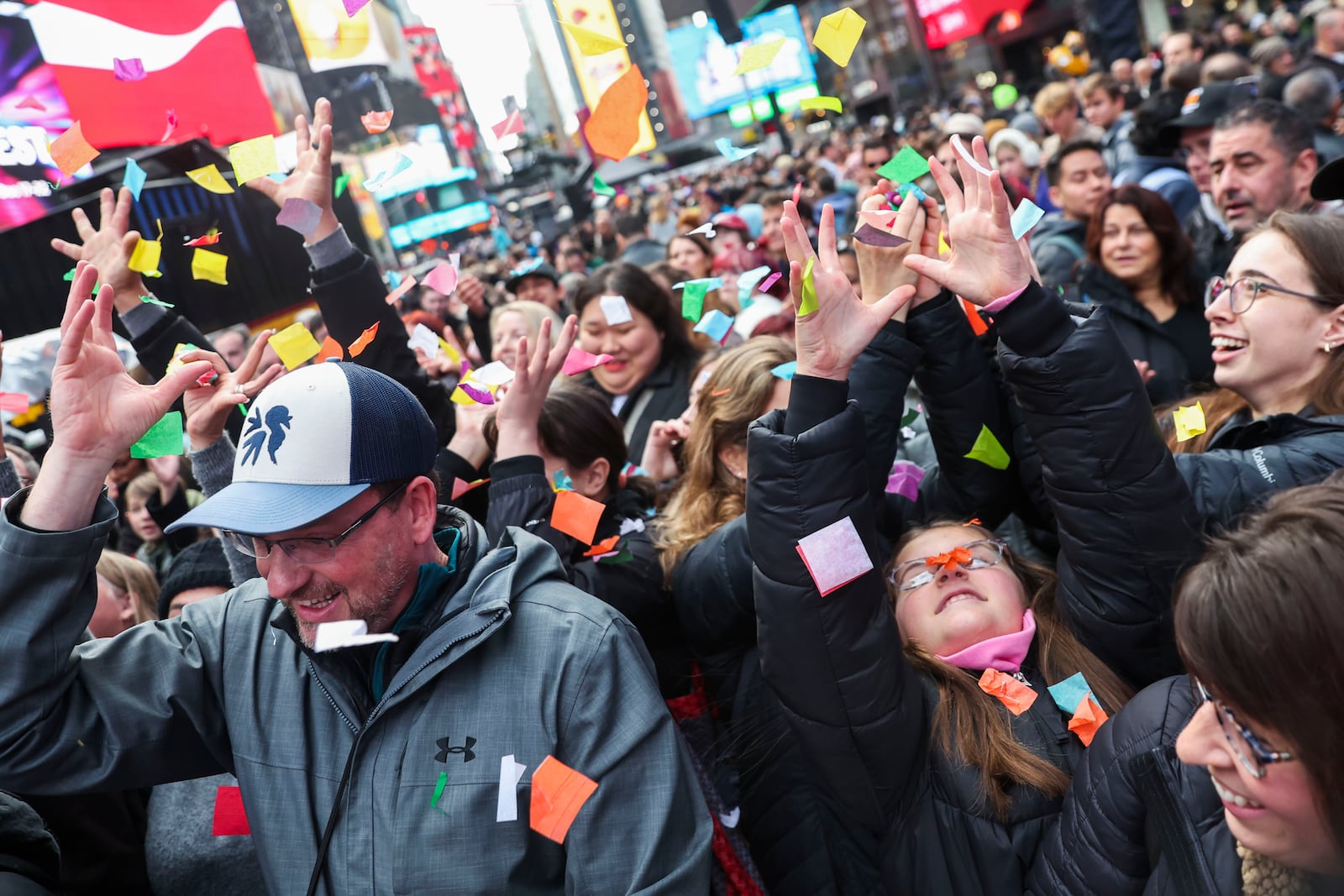 People in the crowd catch confetti ahead of New Year's Eve in Times Square, Sunday, Dec. 29, 2024, in New York. (AP Photo/Heather Khalifa)