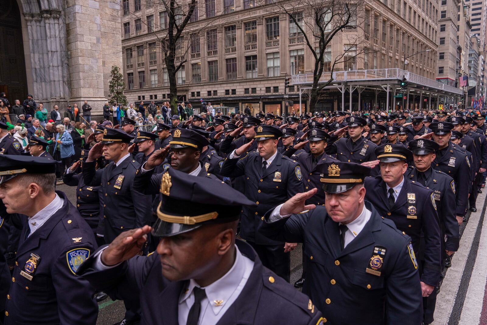 NYPD officers salute as they march in the 264th New York City Saint Patrick's Day Parade, Monday, March 17, 2025 in New York. (AP Photo/Adam Gray)