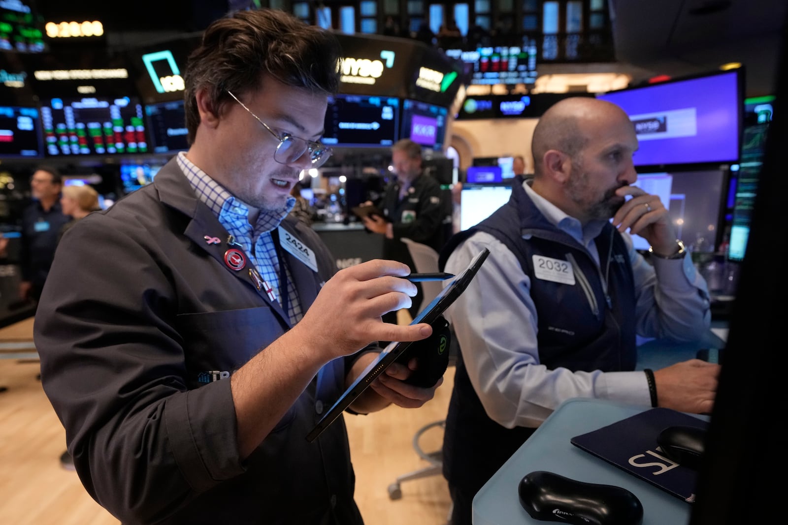 Trader William Lovesick, left, and specialist James Denaro work on the floor of the New York Stock Exchange, Friday, Nov. 8, 2024. (AP Photo/Richard Drew)