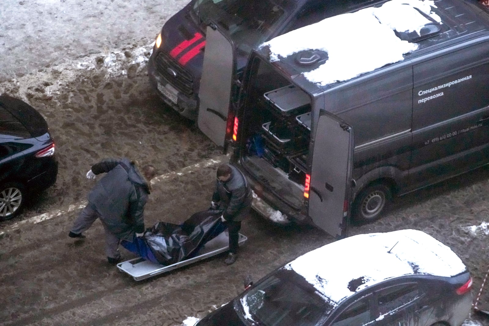 Workers load a body of Lt. General Igor Kirillov, the head of Russia's Nuclear, Biological, and Chemical Defence Forces into a bus after he and his assistant Ilya Polikarpov were killed by an explosive device planted close to a residential apartment's block in Moscow, Russia, Tuesday, Dec. 17, 2024. (AP Photo)