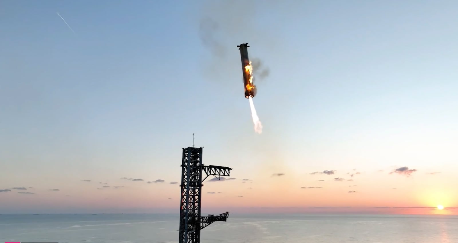 This image provided by SpaceX shows SpaceX's mega rocket booster returning to the launch pad to be captured during a test flight Sunday, Oct. 13, 2024, in Boca Chica, Texas. (SpaceX via AP)