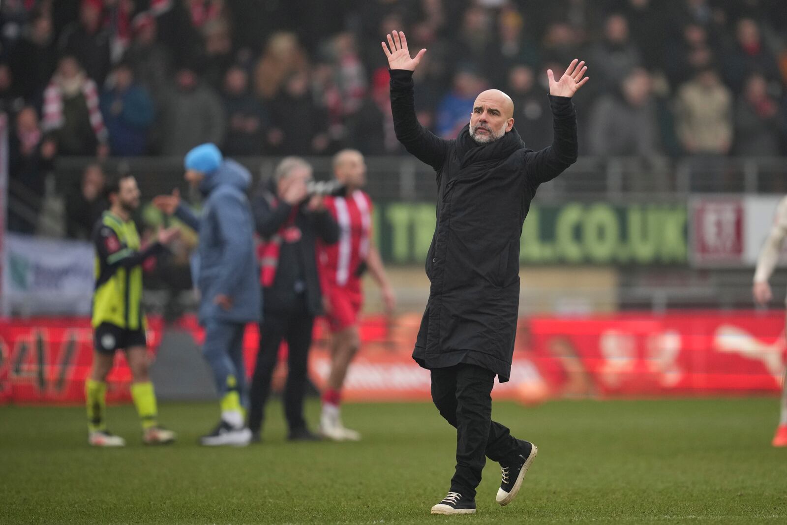 Manchester City's head coach Pep Guardiola celebrates at the end of the English FA Cup fourth round soccer match between Leyton Orient and Manchester City at the Gaughan Group Stadium in London, England, Saturday, Feb. 8, 2025. (AP Photo/Kin Cheung)