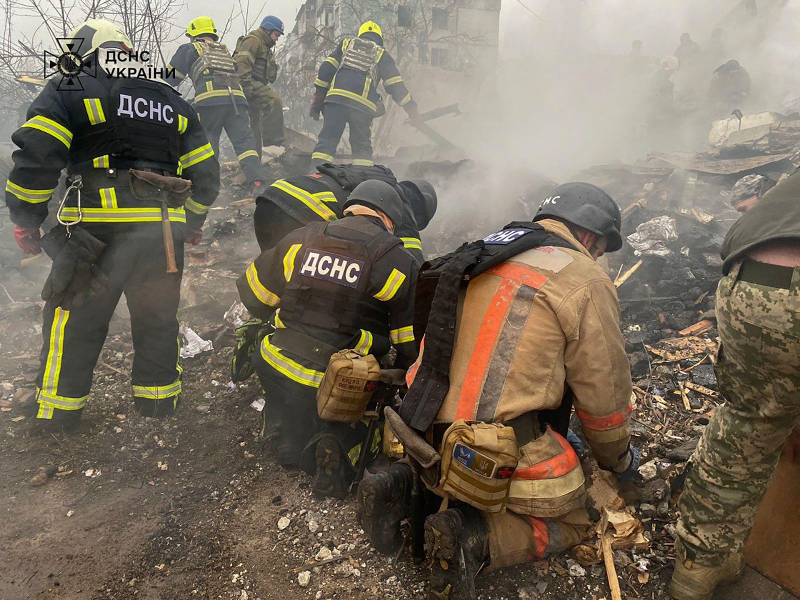 In this photo provided by the Ukrainian Emergency Service, firefighters clear the rubble and search for victims in a ruined apartment building following a Russian rocket attack in Poltava, Ukraine, Saturday, Feb. 1, 2025. (Ukrainian Emergency Service via AP)