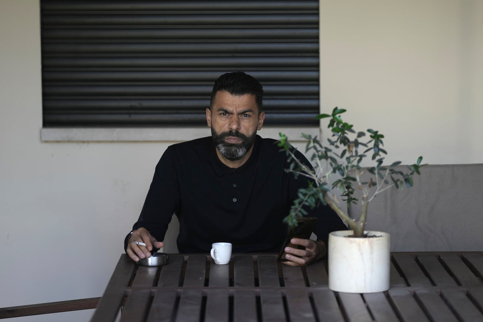 Ahmed Khalefa, a Palestinian citizen of Israel who is charged with incitement to terrorism for demonstrating against the war in Gaza, is seen at home in Umm al-Fahm, Israel, Wednesday, Nov. 20, 2024. (AP Photo/Mahmoud Illean)