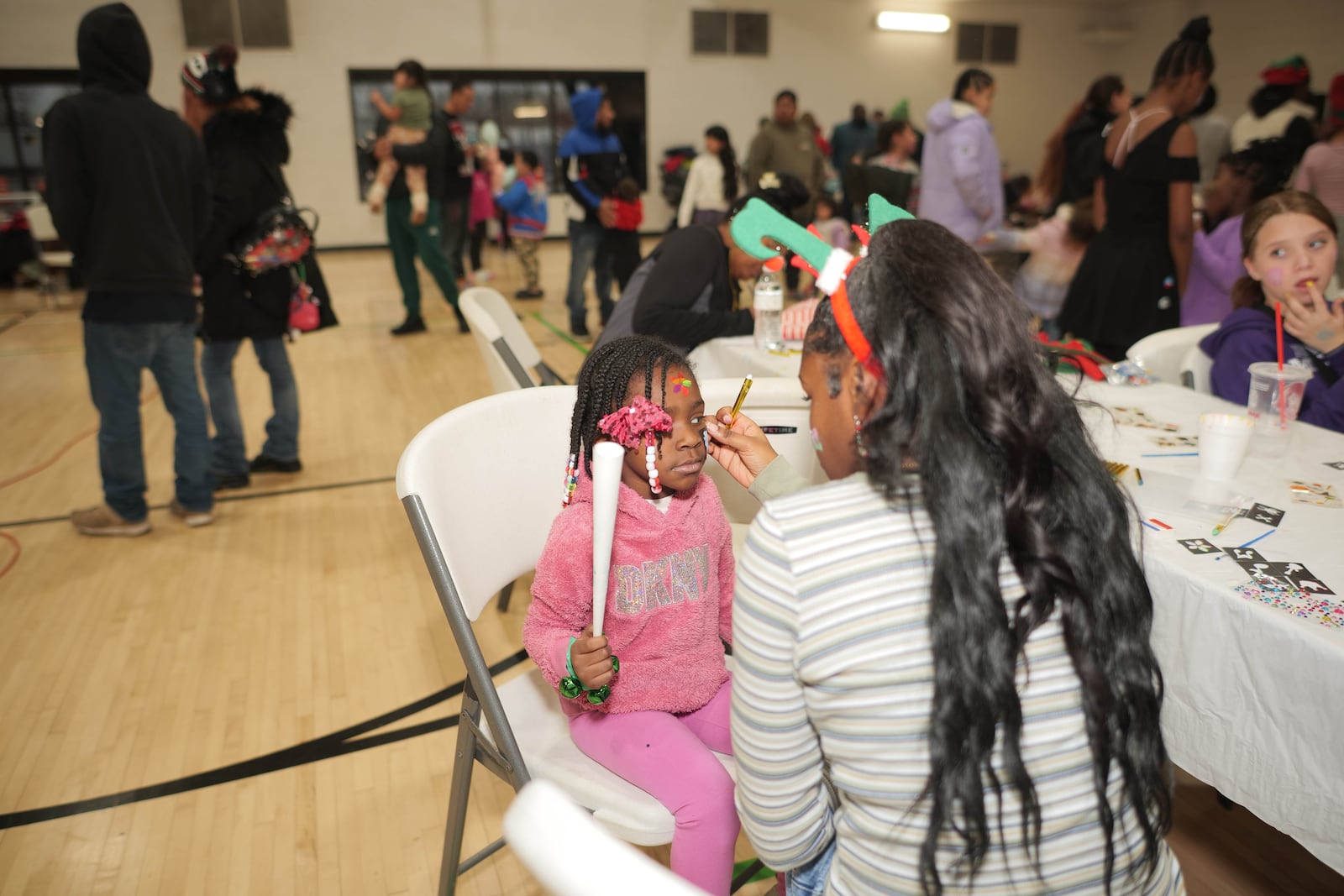 The 17th annual Louella Thompson's Feed the Hungry Toy Giveaway last week provided free face painting, pictures with Santa, food, games and a raffle for 200 bikes. PHOTO COURTESY OF ALFREDO PETERS