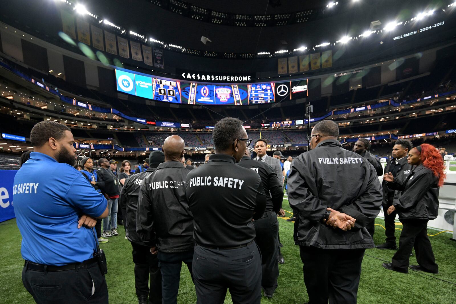 Public safety officials stand on the field before the quarterfinals of a College Football Playoff between Georgia and Notre Dame, Thursday, Jan. 2, 2025, in New Orleans. (AP Photo/Matthew Hinton)