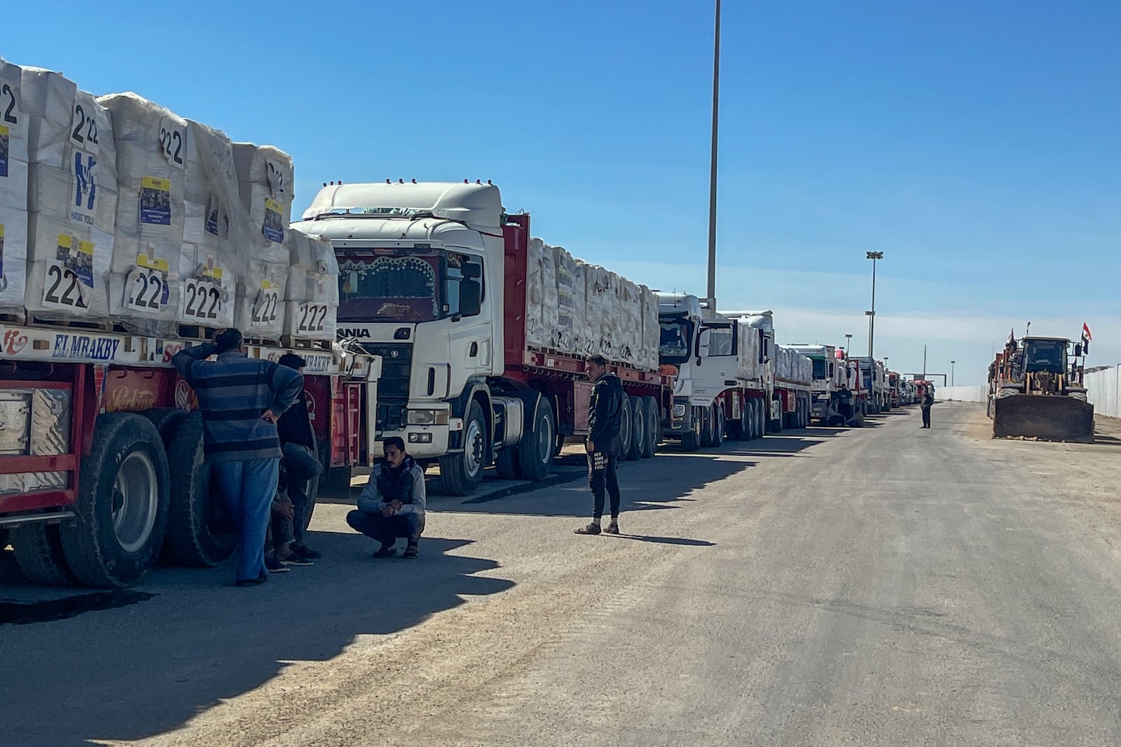 Trucks line up at the Egyptian side of the Rafah border crossing between Egypt and the Gaza Strip on Sunday, March 2, 2025. (AP Photo/Mohamed Arafat)