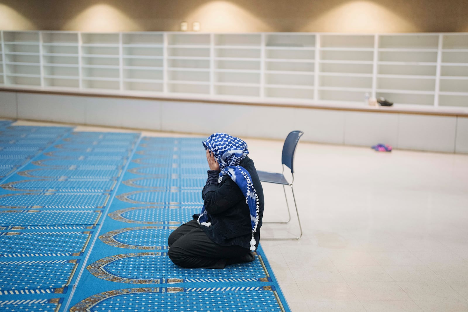 A woman prays during a community gathering to discuss plans for Ramadan held for members of Masjid Al-Taqwa at a school in Pasadena, California, Saturday, Feb. 15, 2025. (AP Photo/Eric Thayer)