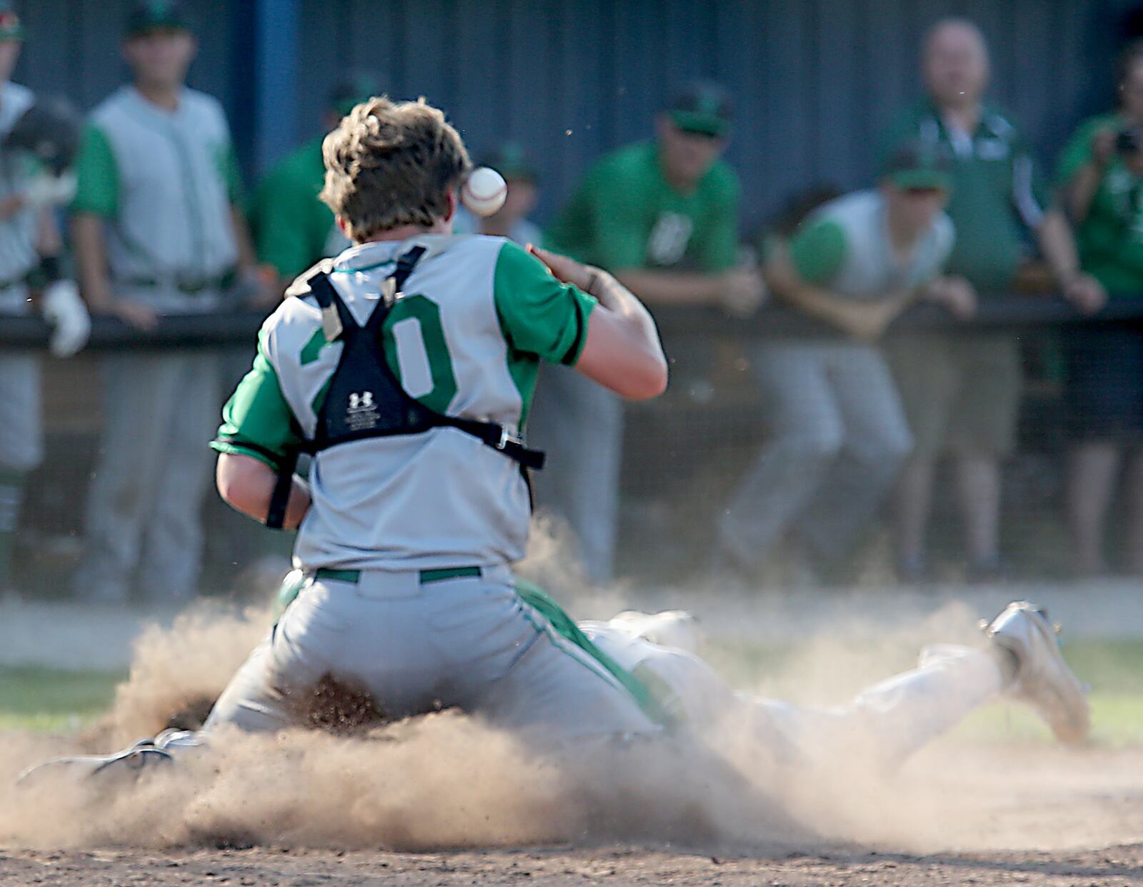 Badin catcher Zac Wilson has trouble getting a grip on the ball as Chaminade Julienne’s Cameron Benoit scores the winning run during Thursday’s Division II sectional final at Miamisburg. CONTRIBUTED PHOTO BY E.L. HUBBARD