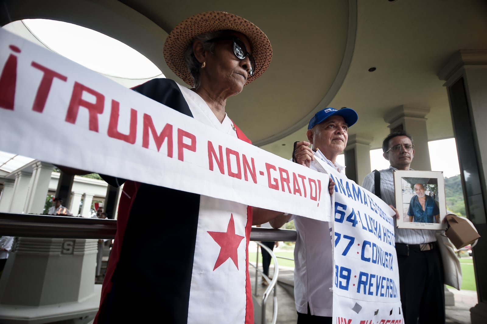 A woman holds up a banner with a message that reads in Spanish; "Trump persona non grata!", during a demonstration marking Martyrs' Day, a national day of mourning to honor the 21 Panamanians who were killed during the January 1964 anti-American riots over sovereignty of the Panama Canal Zone, in Panama City, Thursday, Jan. 9, 2025. (AP Photo/Agustin Herrera)