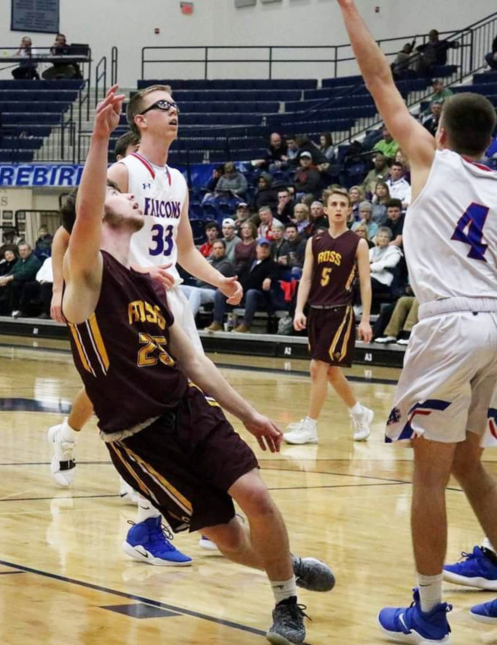 Cole Gronas of Ross (25) puts up an off-balance shot over Clinton-Massie’s Zach Chowning (4) during Friday night’s Division II sectional basketball game at Fairmont’s Trent Arena in Kettering. Clinton-Massie won 61-54 in overtime. CONTRIBUTED PHOTO BY TERRI ADAMS