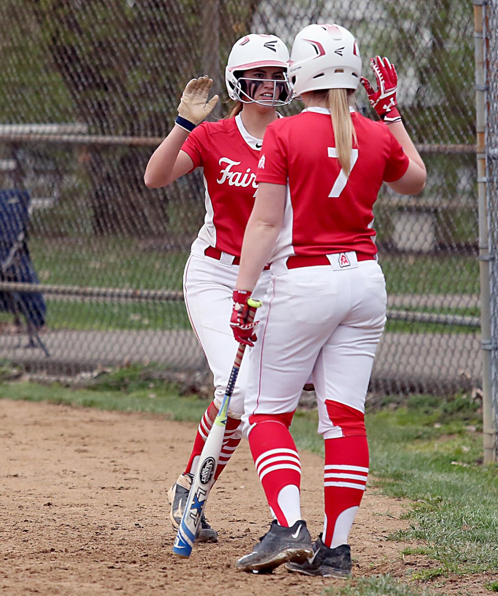 Fairfield’s Maddie Koger is congratulated by teammate Erin Burdine (7) after scoring a run against Sycamore during Tuesday’s game at Fairfield Middle School. CONTRIBUTED PHOTO BY E.L. HUBBARD