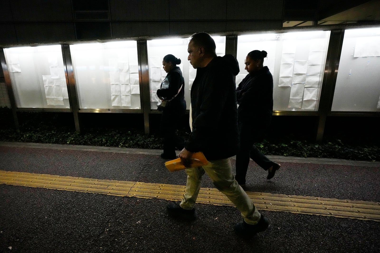 Family members of Australian citizen Donna Nelson walk out from the Chiba District Court after the opening day of the trial over Nelson for allegedly attempting to import drugs into Japan Monday, Nov. 18, 2024, in Chiba, east of Tokyo. (AP Photo/Eugene Hoshiko)