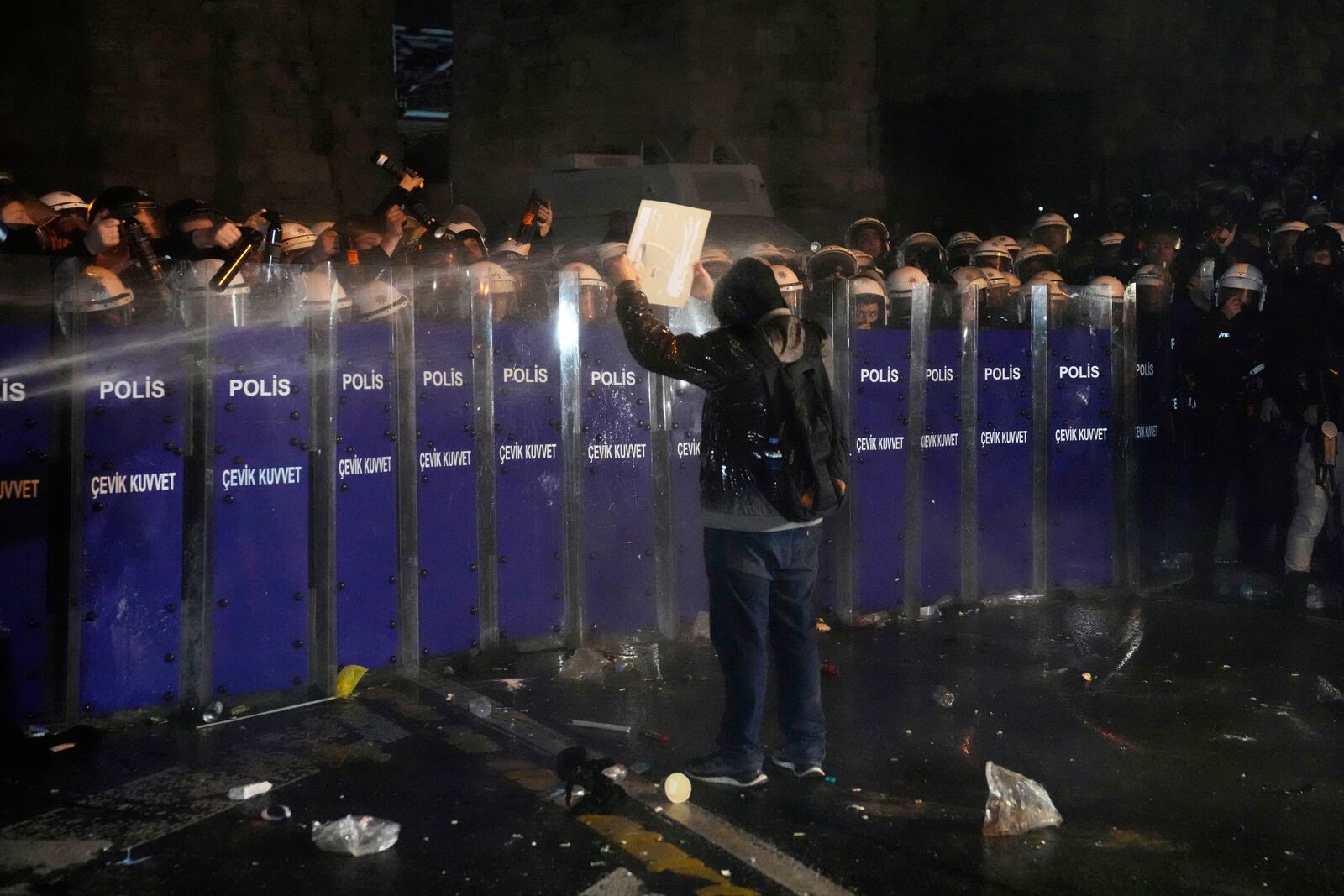 Police officers use pepper spray during clashes with people as they protest against the arrest of Istanbul's Mayor Ekrem Imamoglu, in Istanbul, Turkey, Friday, March 21, 2025. (AP Photo/Khalil Hamra)