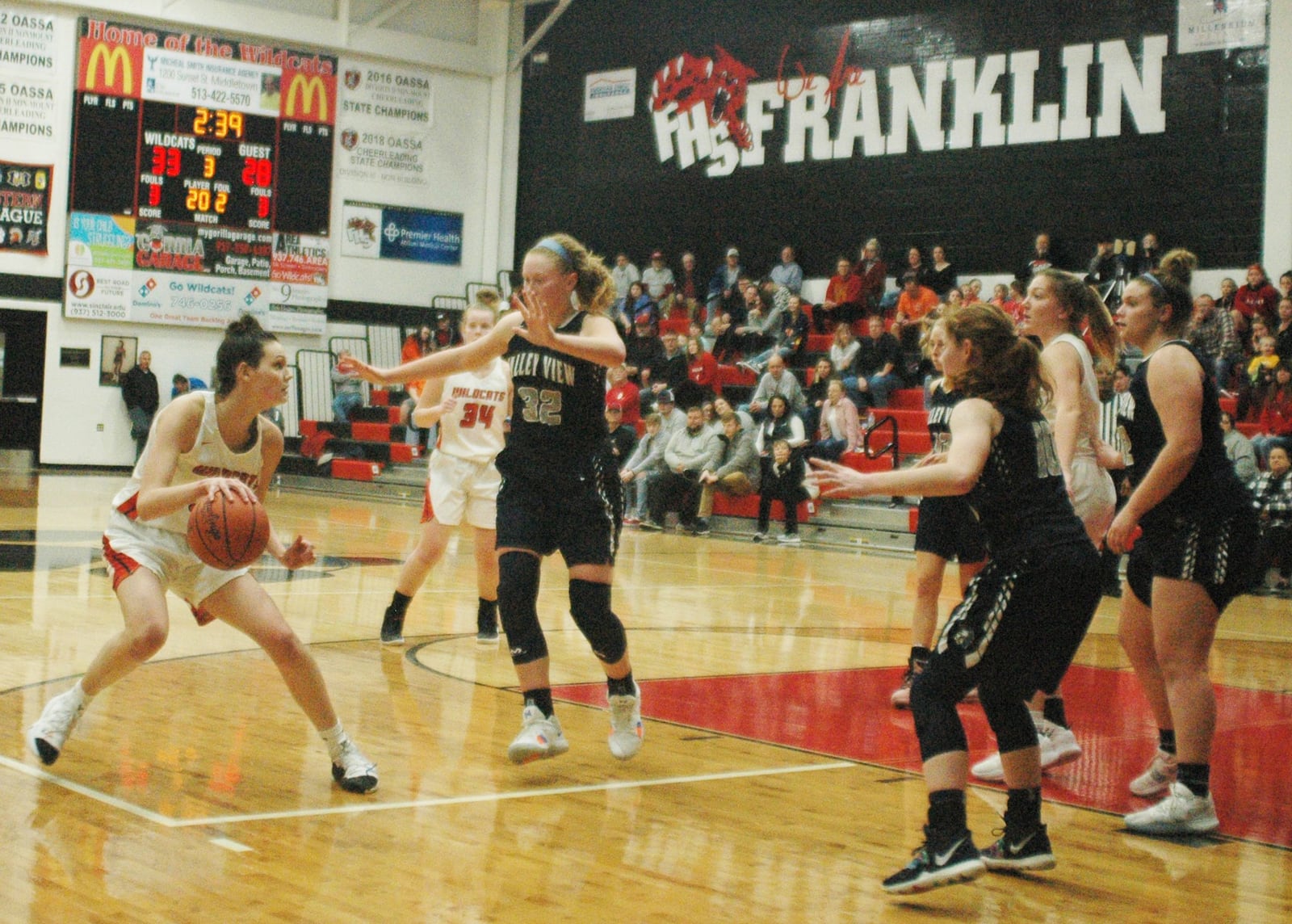 Franklin’s Layne Ferrell (30) prepares to drive into the Valley View defense, which includes Aubrey Stupp (32) and Abigail Dickson (10), during Monday night’s game at Darrell Hedric Gym in Franklin. The host Wildcats won 55-45. RICK CASSANO/STAFF