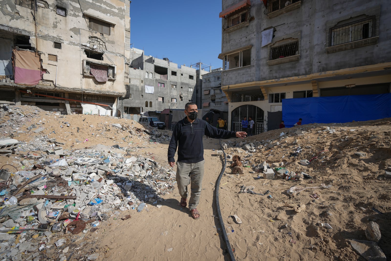 Ahmed Algharbli shows the area where he last saw his father, Mahmoud Alghrabli, in Khan Younis, Gaza Strip, Nov. 21, 2024. (AP Photo/Abdel Kareem Hana)