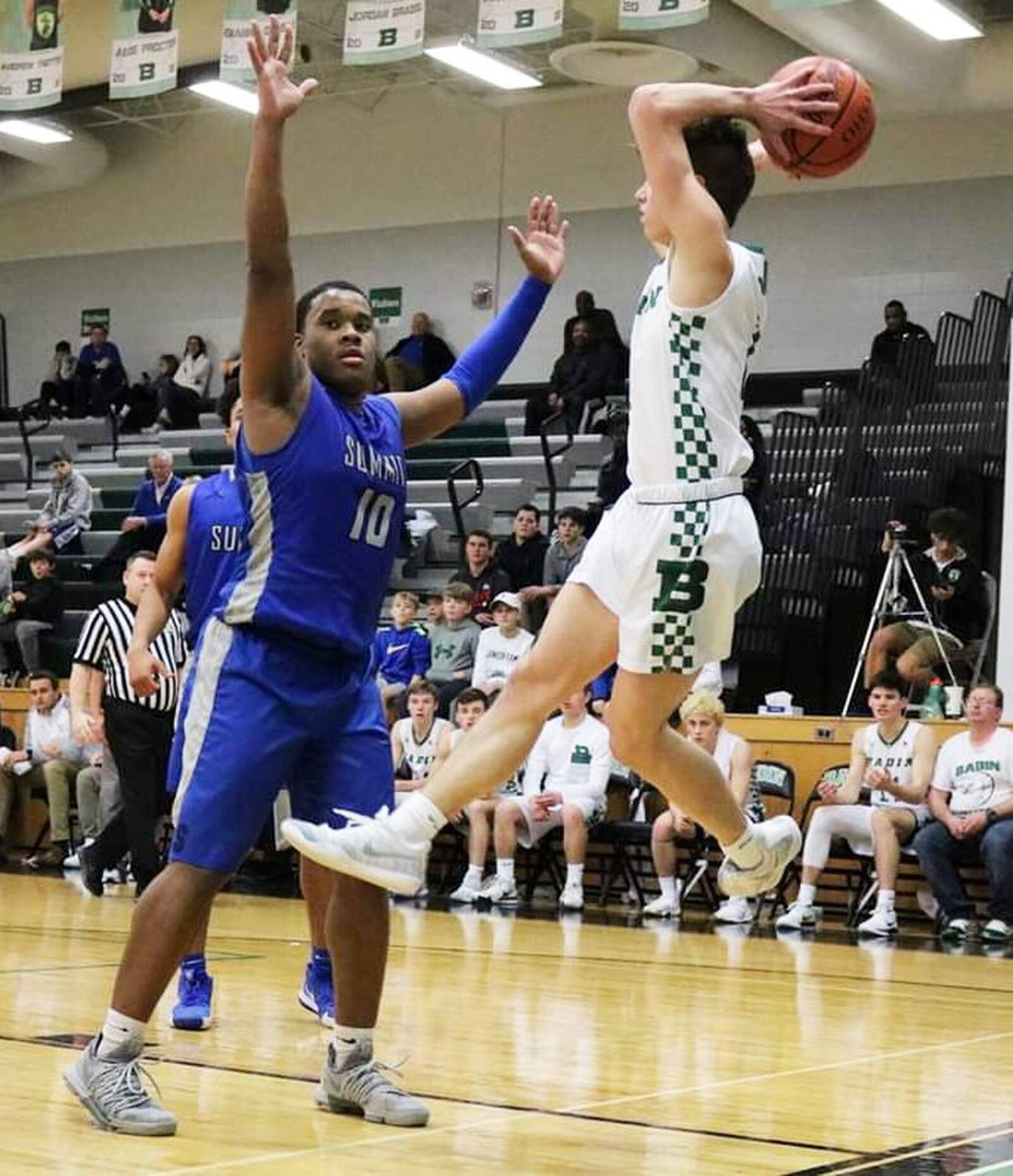 Badin’s Joseph Walsh saves the ball from going out of bounds as Summit Country Day’s Rylan Woods defends during Tuesday night’s game at Mulcahey Gym in Hamilton. Badin won 49-39. CONTRIBUTED PHOTO BY TERRI ADAMS