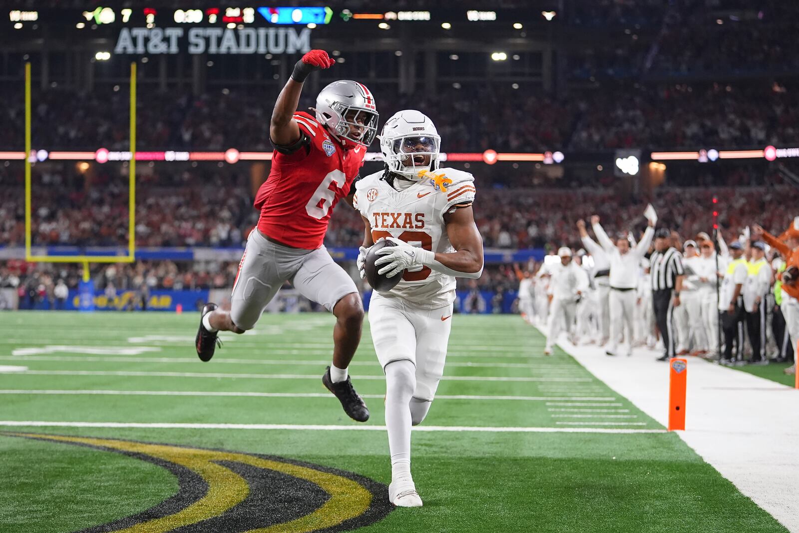 Texas running back Jaydon Blue, foreground, catches a touchdown pass against Ohio State safety Sonny Styles (6) during the first half of the Cotton Bowl College Football Playoff semifinal game, Friday, Jan. 10, 2025, in Arlington, Texas. (AP Photo/Julio Cortez)