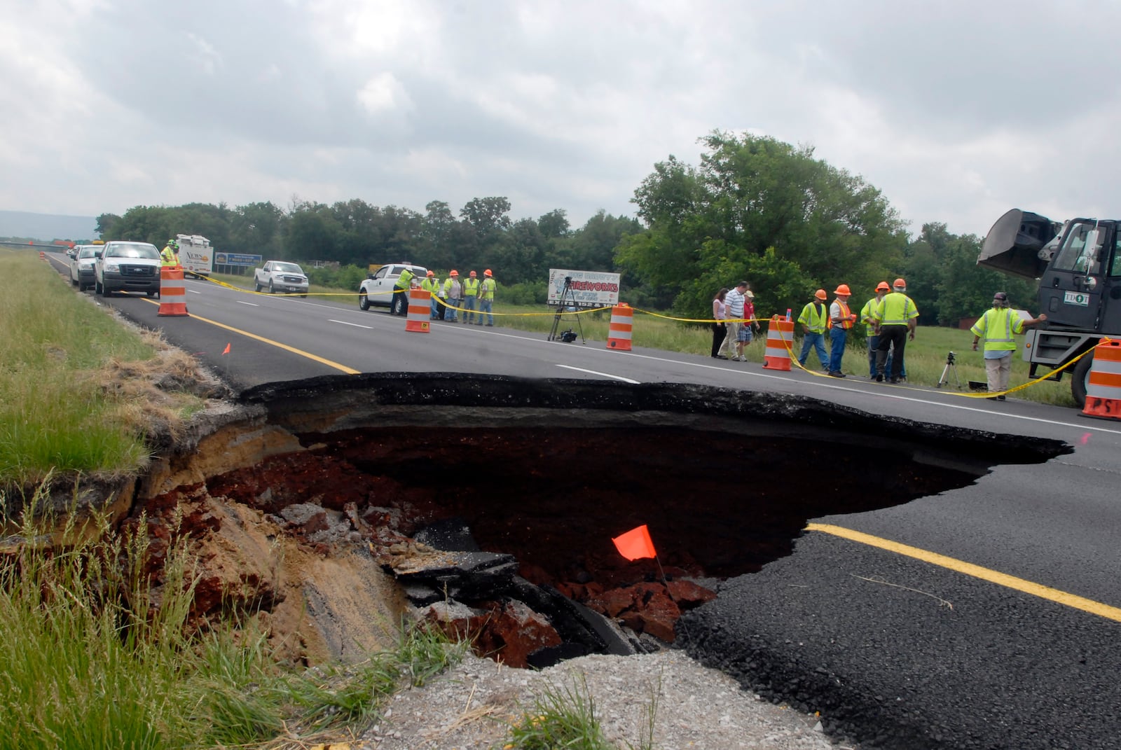 FILE - TDOT workers assess damage done by a sinkhole on eastbound Interstate 24 near Grundy County Tuesday May 18, 2010 near Chattanooga, Tenn. (Danielle Moore/Chattanooga Times Free Press via AP, File)