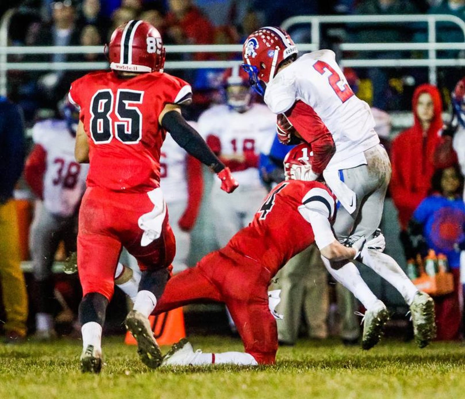 Madison’s Noah Lehman (14) makes a tackle as teammate P.J. Schenck (85) watches during last Saturday’s 26-0 victory over Portsmouth in a Division V, Region 20 quarterfinal at Brandenburg Field in Madison Township. NICK GRAHAM/STAFF