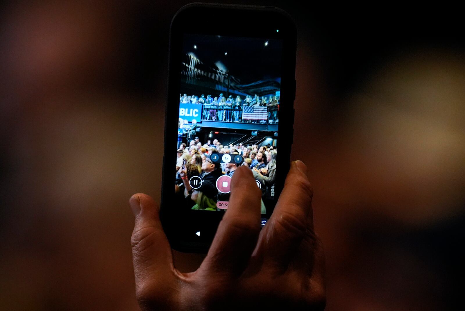 A supporter uses their phone during a Rally for our Republic gathering, Saturday, March 22, 2025, in Atlanta. (AP Photo/Mike Stewart)