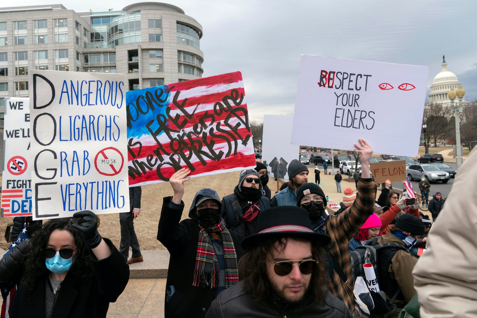 People protest during a rally against Elon Musk outside the U.S. Department of Labor in Washington, Wednesday, Feb. 5, 2025. (AP Photo/Jose Luis Magana)