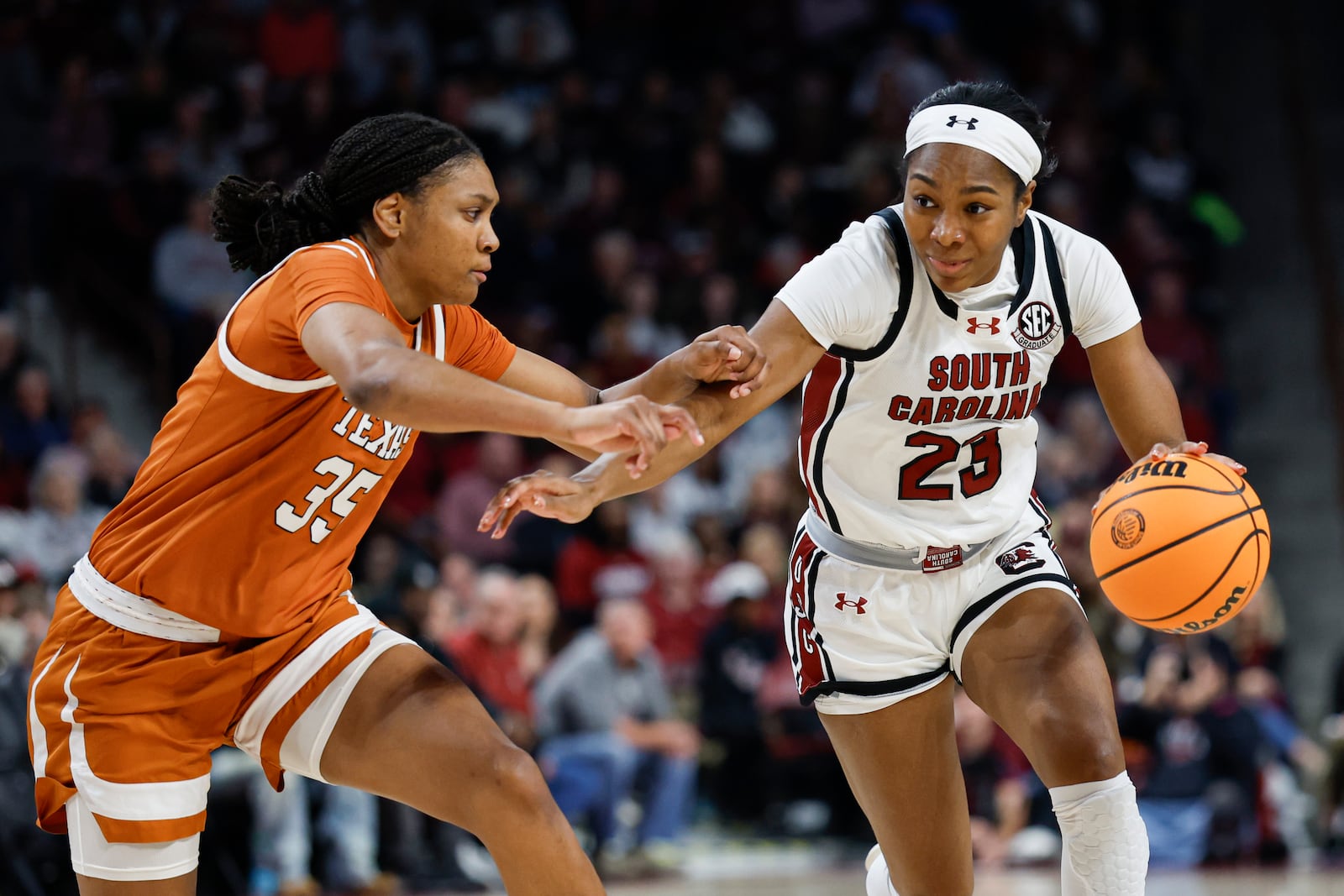 South Carolina guard Bree Hall (23) drives against Texas forward Madison Booker during the first half of an NCAA college basketball game in Columbia, S.C., Sunday, Jan. 12, 2025. (AP Photo/Nell Redmond)