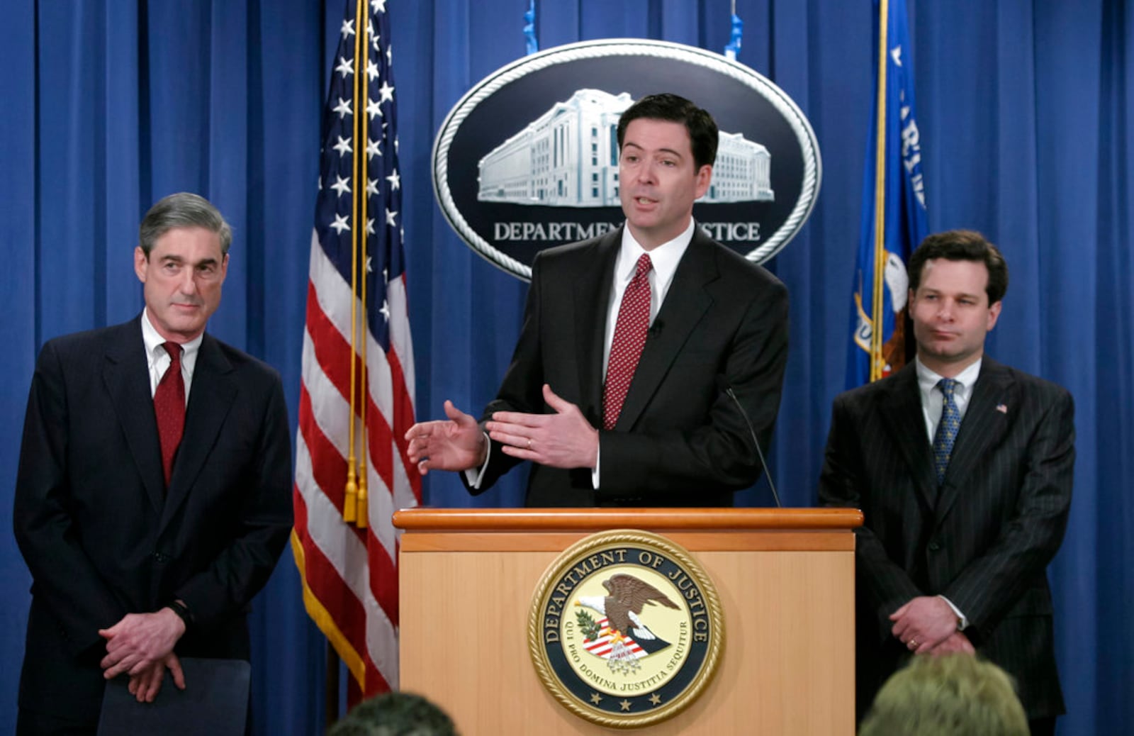 In this photo from Thursday, Feb. 19, 2004, FBI Director Robert Mueller, left, Deputy Attorney General James B. Comey, head of the Justice Department's corporate fraud task force, and Assistant Attorney General Christopher Wray of the Justice Department Criminal Division, right, announce charges against Enron chief executive Jeffrey Skilling, in Washington. Today, 14 years later in April 2018, Christopher Wray is President Donald Trump's FBI director, taking over after Trump fired James B. Comey May 9, 2017, who had served as FBI director since 2013. On May 17, 2017. Robert Mueller was appointed as a special counsel to investigate Russian meddling in the U.S. election and whether there were any links or coordination between Russian government and individuals associated with the campaign of President Donald Trump. (AP Photo/J. Scott Applewhite)